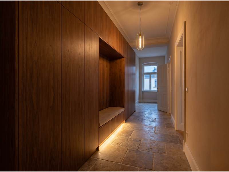 Custom walnut hallway storage with bench in an old building, Dresden